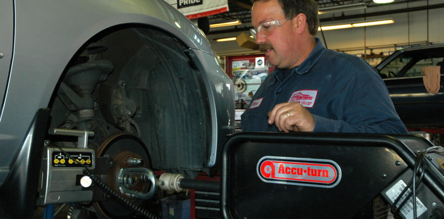 Technician working by a car - Leon's Car Care Center